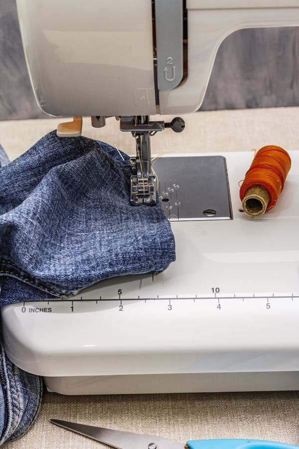 Sewing Machine Foot on Denim. Scissors, Spools of Thread Stock Image
