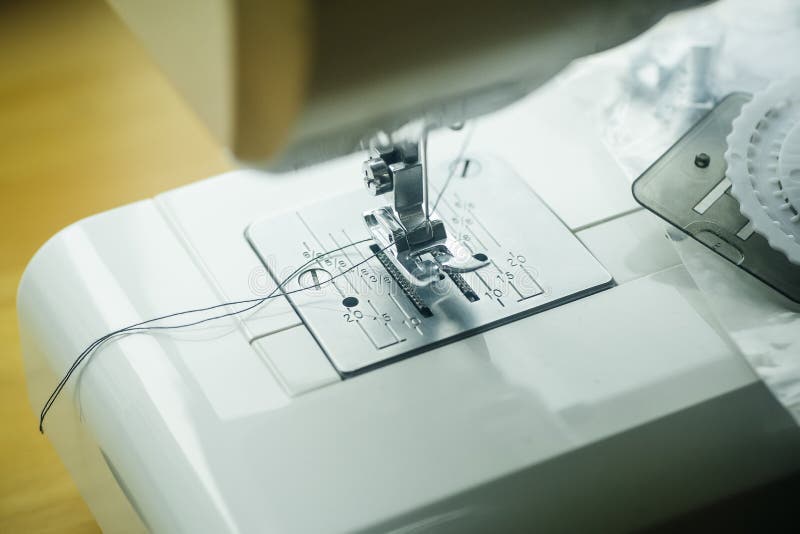 Sewing Machine. Modern Sewing Machine with a Needle and Thread for