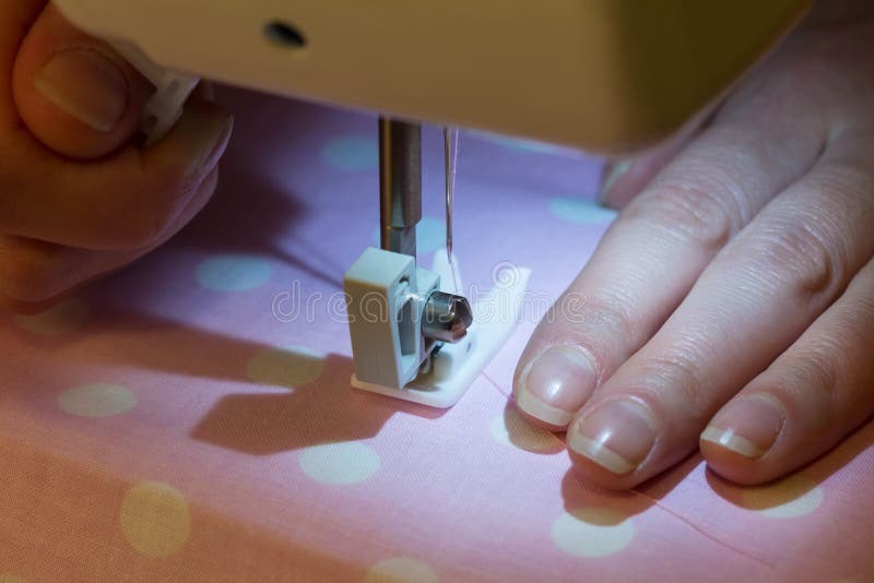 Sewing Machine is in Operation, Hands of Seamstress and Fabric Stock