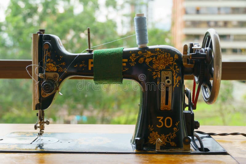 Sewing machine with tread stock image