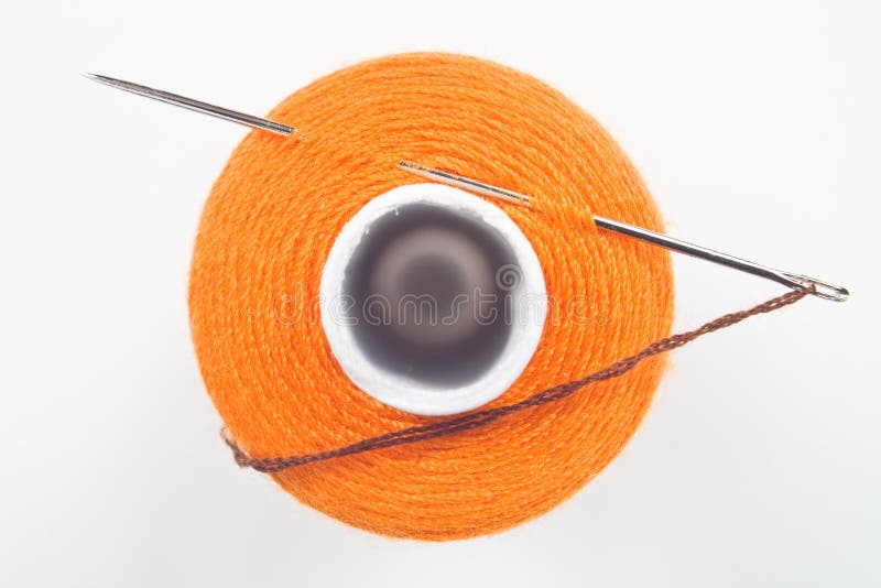 Sewing spool with a needle