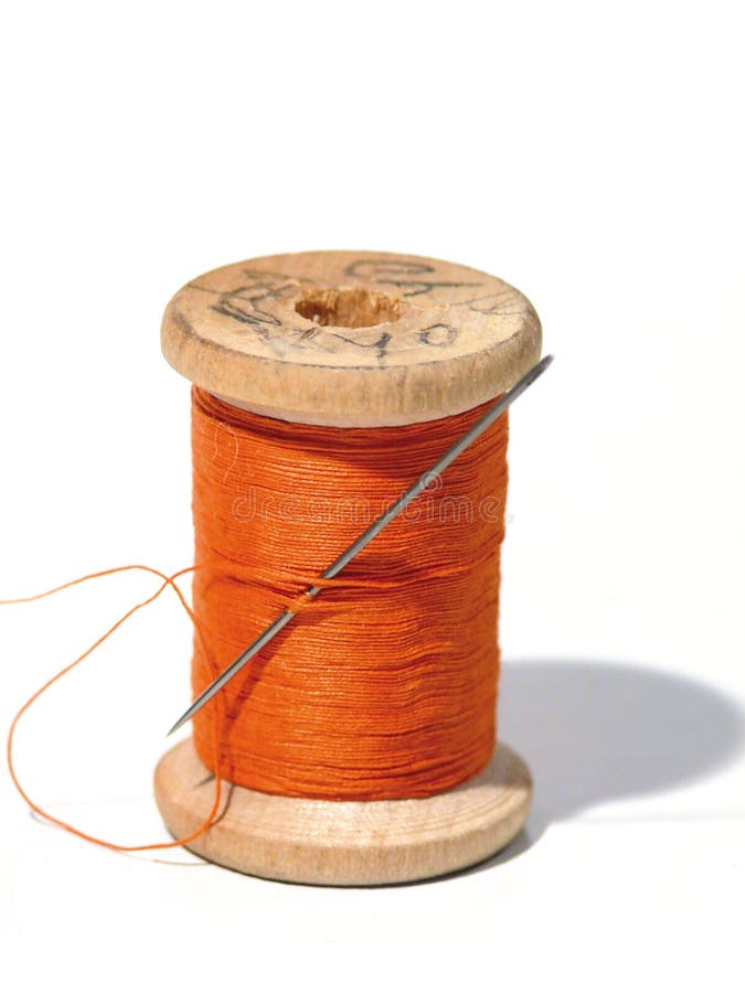 Sewing spool with a needle. A sewing needle.