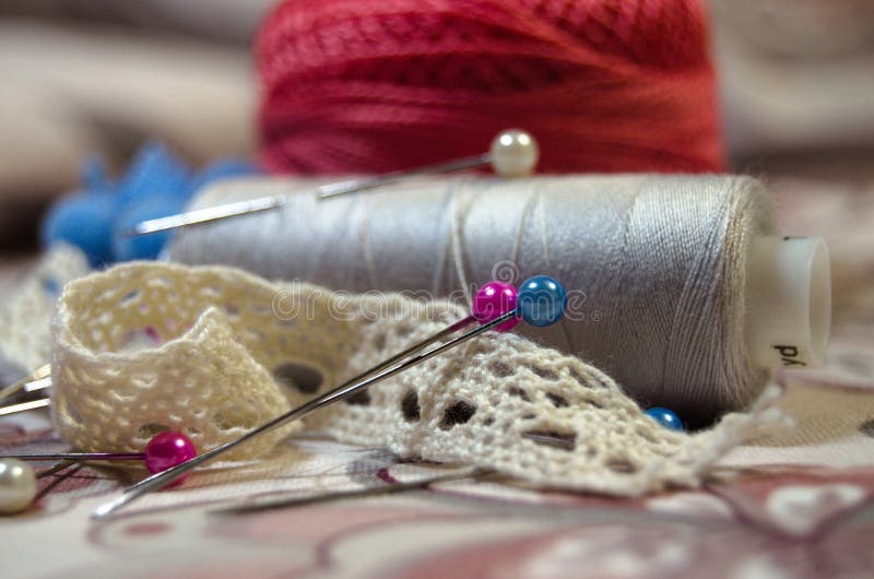 Sewing Threads with Needles and Beige Cotton Lace Closeup Stock Image