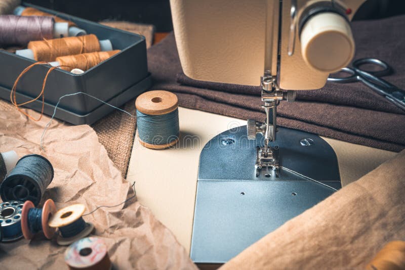 Sewing workplace with sewing machine and thread. royalty free stock photography