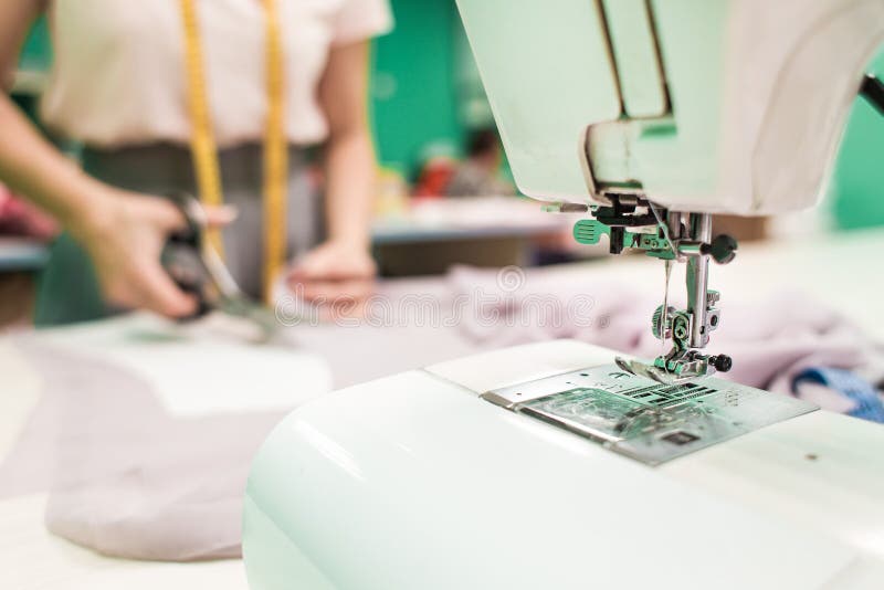 Sewing Seamstress at Work. Marking and Cutting Fabric. Stock