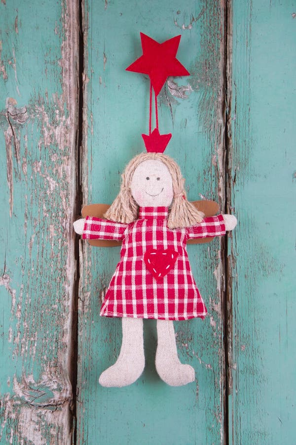 Sewn angel doll hanging on turquoise wood board - christmas