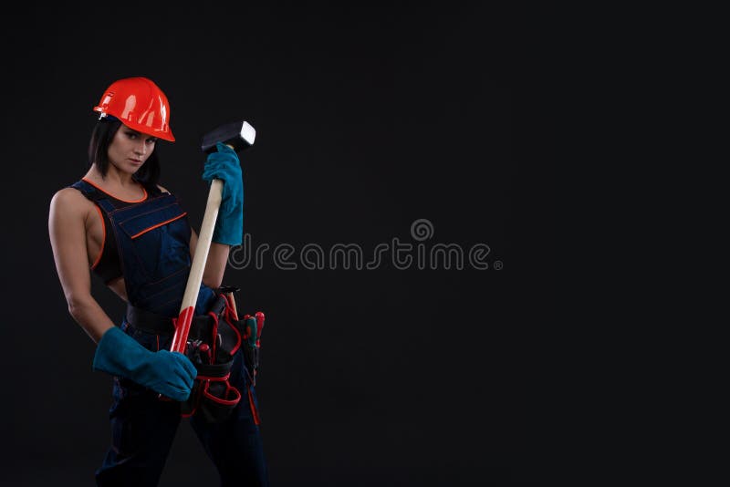 Sex equality and feminism. girl in safety helmet holding hammer tool. Attractive woman working as construction worker. stock images Sex equality and feminism. girl in safety helmet holding hammer tool. Attractive woman working as construction worker. stock images