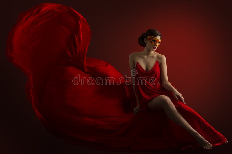 Woman Carnival Mask, Sensual Fashion Model in Silk Flying Gown, Red Fluttering Fabric. Woman Carnival Mask, Sensual Fashion Model in Silk Flying Gown, Red Fluttering Fabric