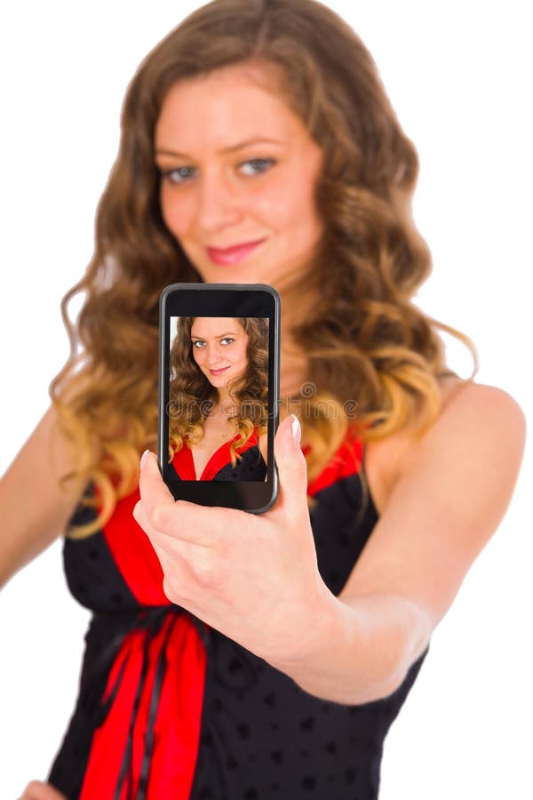 Gorgeous woman smiling kindly taking a selfie with her smartphone. Gorgeous woman smiling kindly taking a selfie with her smartphone.