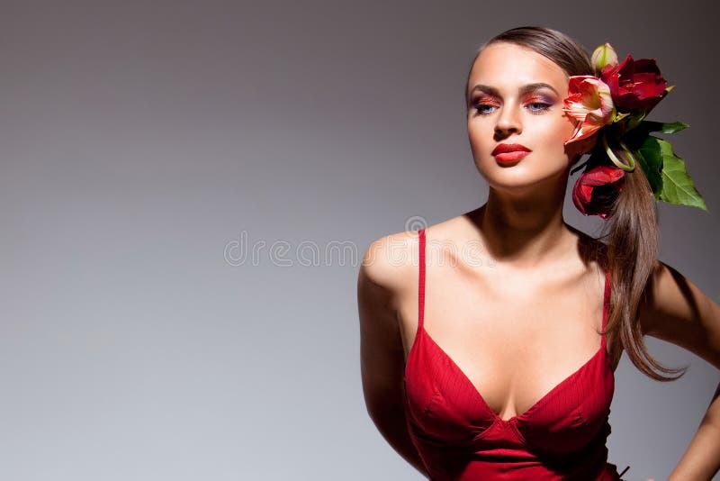 Sexual girl in red dress with flowers in her hair