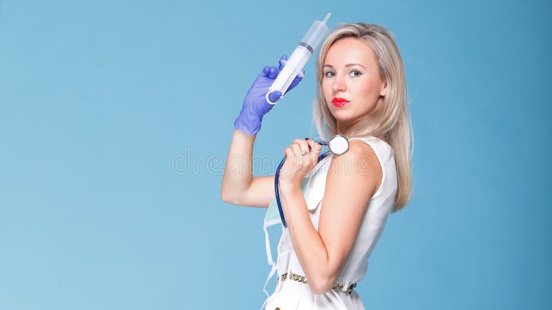 Sexual woman in nurse suit with syringe blue