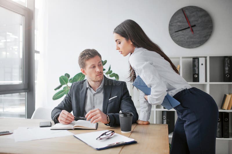 Sexual Young Woman Lean To Table. she Looks at Her Boss. Young Man Sit at  Table and Look at Her Breast. Guy is Excited. Stock Photo - Image of  technology, young: 136080670