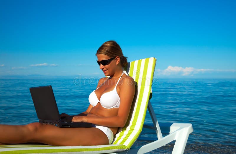 beautiful woman in bikini using laptop