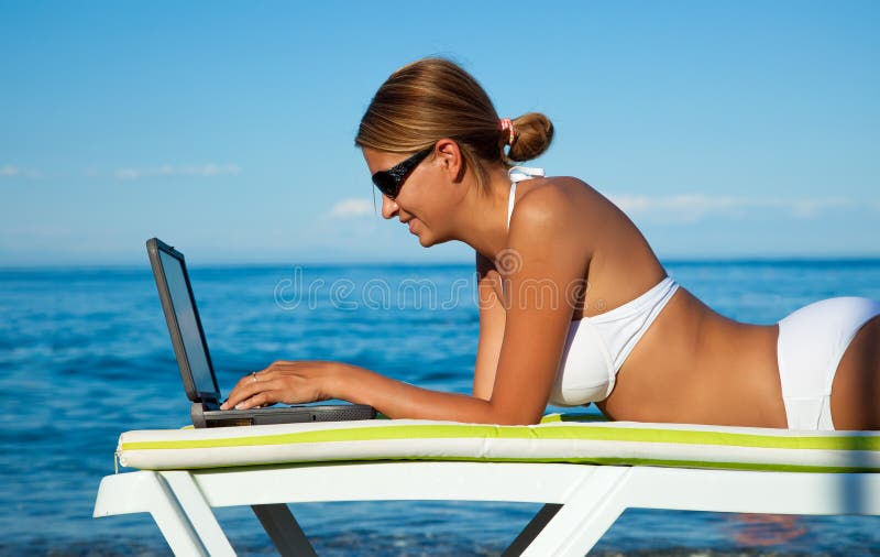 beautiful woman in bikini using laptop