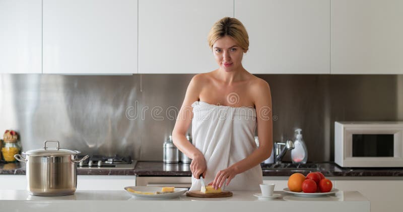 sexy and beautiful girl in lingerie in the kitchen preparing breakfast  Stock Photo