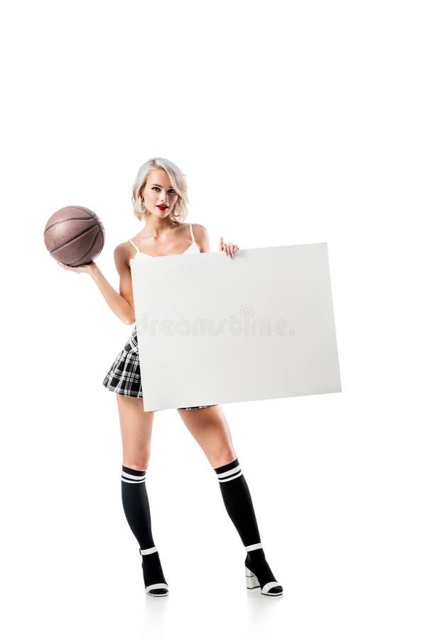 sexy blond woman in short plaid skirt with basketball ball and empty banner posing isolated on white