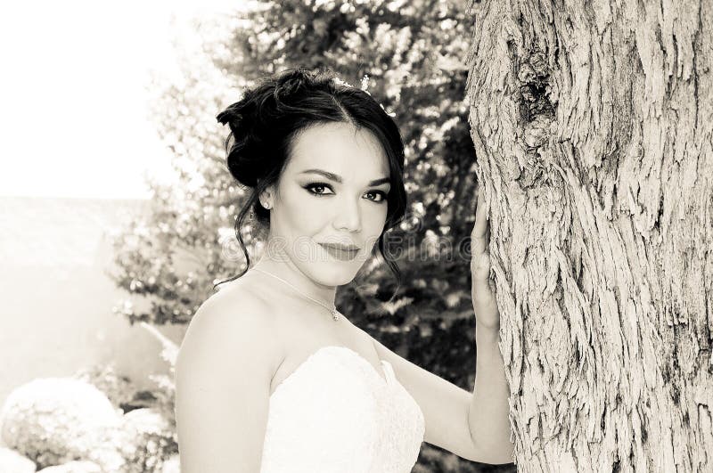 bride posing in her weeding day. Image in sepia, black and white.