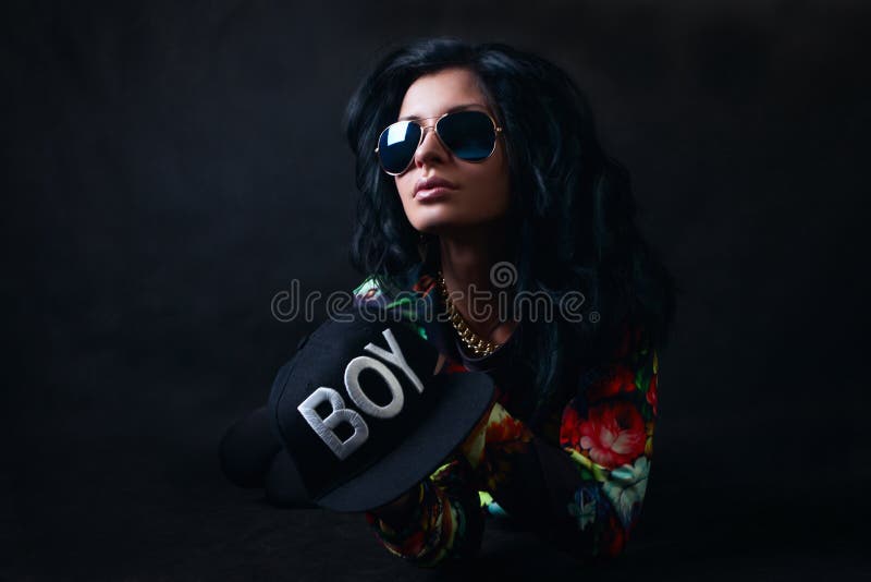 brunette in a black cap and glasses. Swag girl. Fashion stock images brunette in a black cap and glasses. Swag girl. Fashion stock images