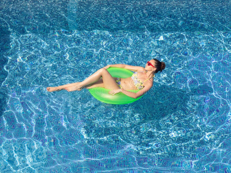 brunette woman tanning on inflatable circle in swimming poo royalty free stock images brunette woman tanning on inflatable circle in swimming poo royalty free stock images