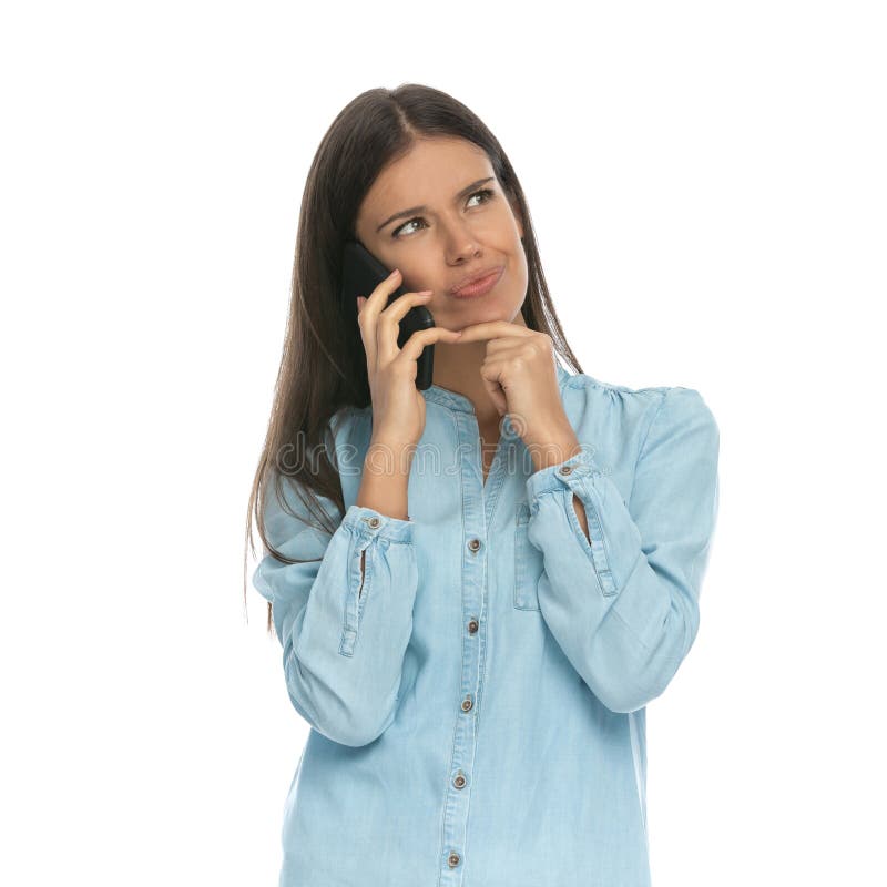 Casual woman talking on the phone and thinking about something