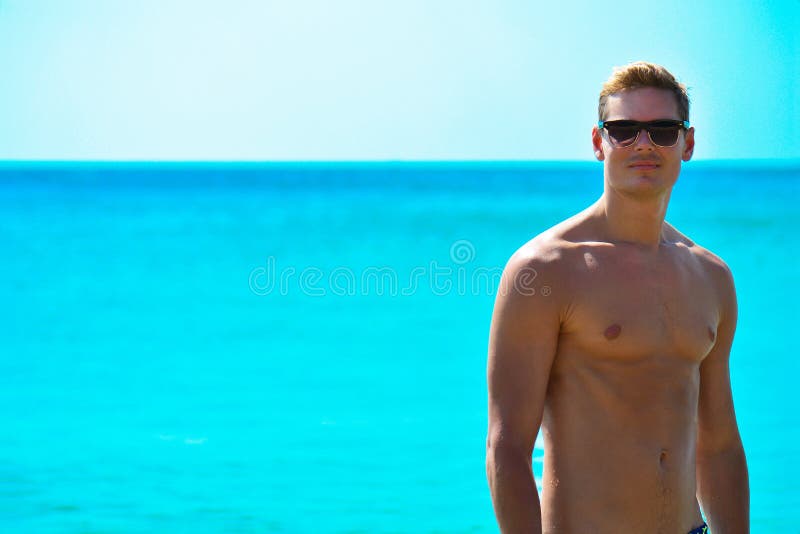 Caucasian Fit Man in Sun Glasses Posing at the Beach. Handsome ...