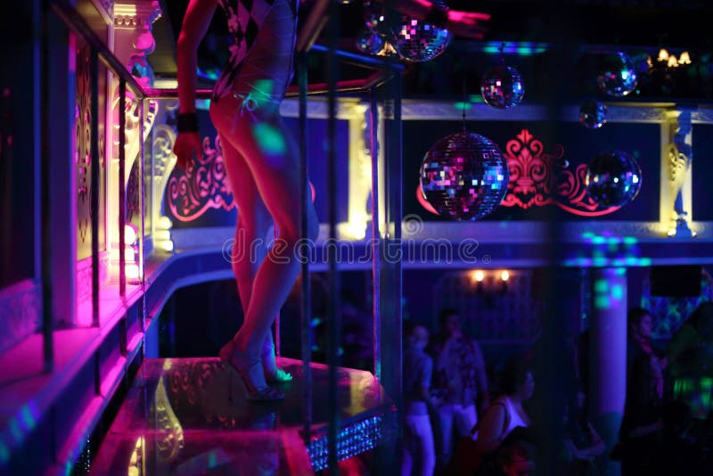 dancer dances on a podium in a nightclub