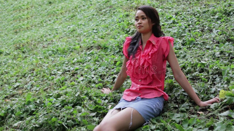 Erotic Asian Girl With Mini Skirt On Green Grass Stock Footage Video