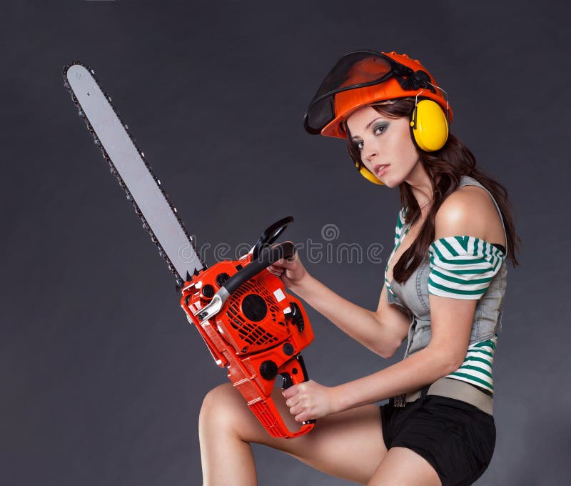 Girl holding a chainsaw stock photo. Image of hair, home 22403930