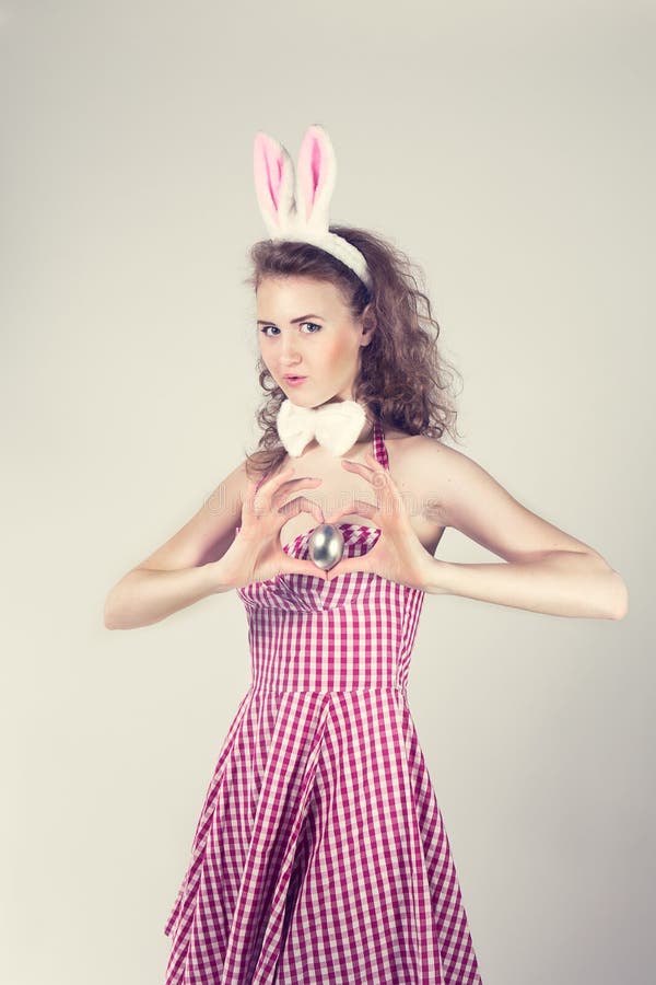 Girl Wearing Easter Bunny Costume with Eggs in Basket Stock Image