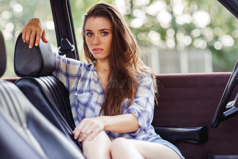 lady posing inside the car and looking at camera royalty free stock images