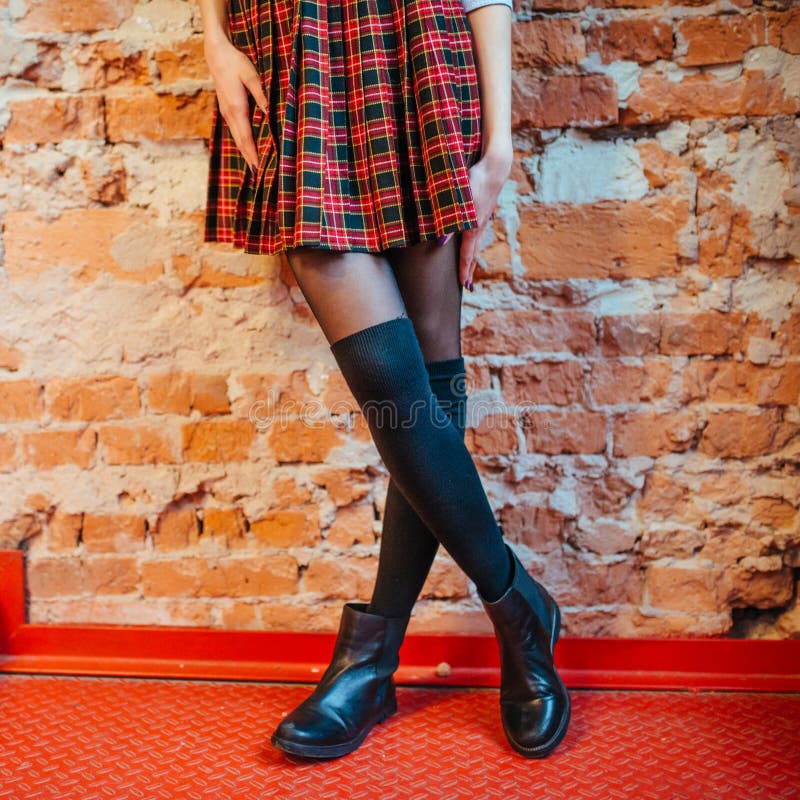 legs of a girl in skirt and black boots stock images legs of a girl in skirt and black boots stock images