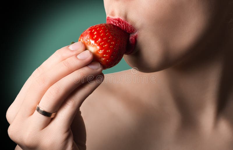 Hot k. Image of red lips kissing strawberry. 