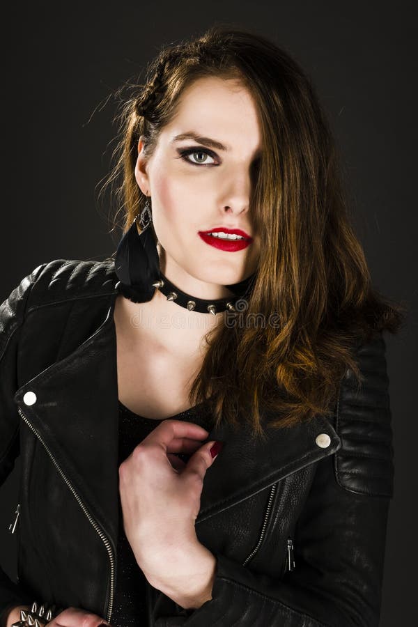 Portrait of a young woman with dramatic make up and rivet collar. Portrait of a young woman with dramatic make up and rivet collar