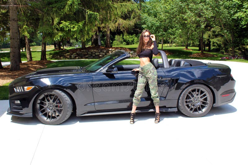 model in sport car beautiful girl with a Ford mustang Roush stage 3 900 HP horse power muscle car.