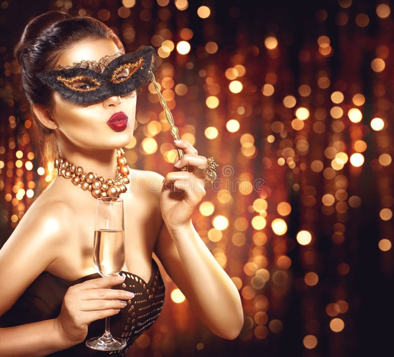 model woman with glass of champagne wearing venetian masquerade mask. model woman with glass of champagne wearing venetian masquerade mask