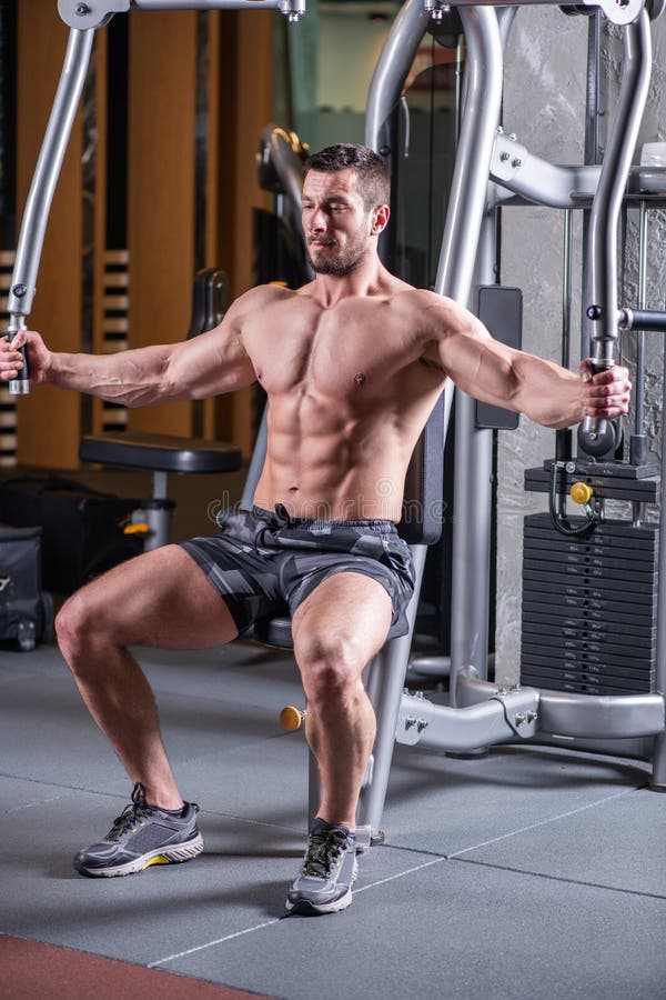 Muscular Man Doing Butterfly Exercise for Chest on the Machine Stock