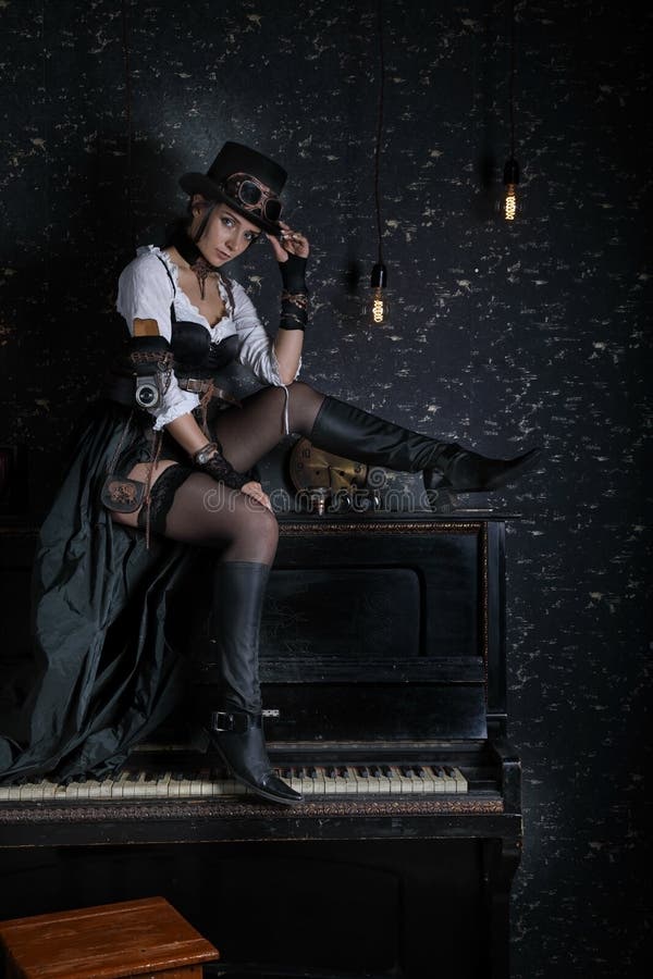Sexy Mädchen steampunk, das zuhause auf Klavier sitzt lizenzfreie stockfotografie Sexy Mädchen steampunk, das zuhause auf Klavier sitzt lizenzfreie stockfotografie