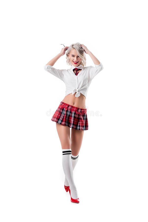 sexy playful woman in short schoolgirl plaid skirt and knee socks with eyeglasses posing isolated on white