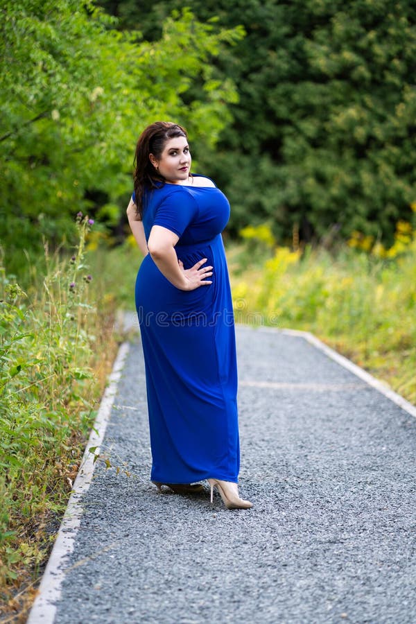 Plus Size Fashion Model in Blue Dress with a Deep Neckline