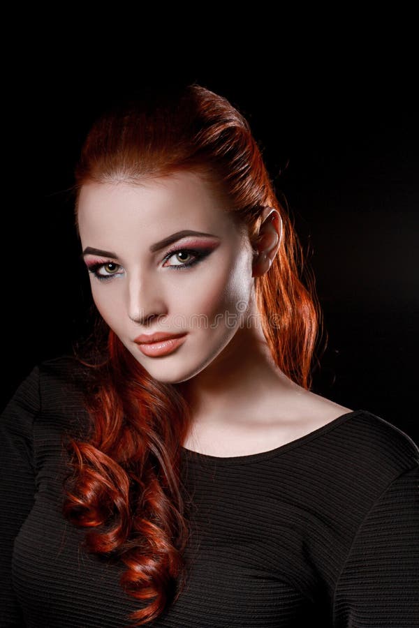 redhead girl in black dress on black background. beauty skincare bussines glamour