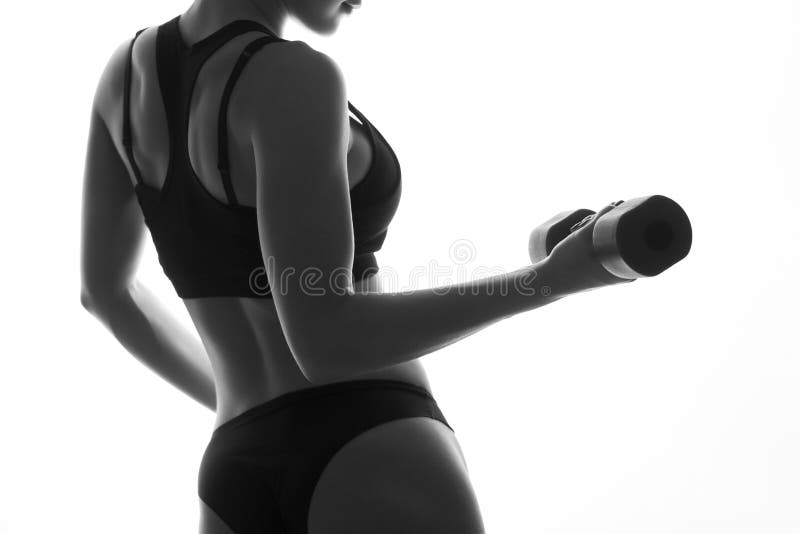 slim fit woman body with dumbbells. Muscled back. Sportswea