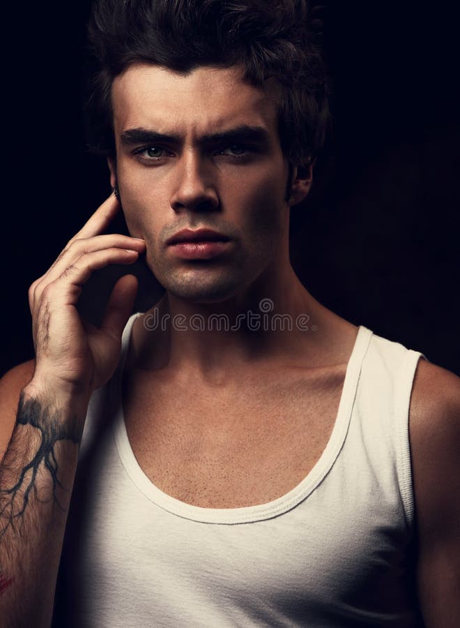 strong young handsome man posing in white t-shirt with hand