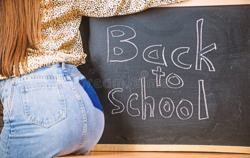 Sexy teacher seduces you to continue studying or enter private school. Buttocks seductive teacher near chalkboard stock images Sexy teacher seduces you to continue studying or enter private school. Buttocks seductive teacher near chalkboard stock images