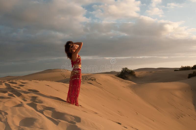 woman belly dancer arabian in desert dunes