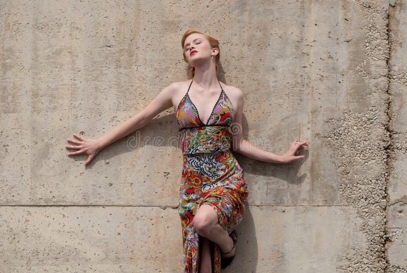 Woman in Dress Leaning Against Wall