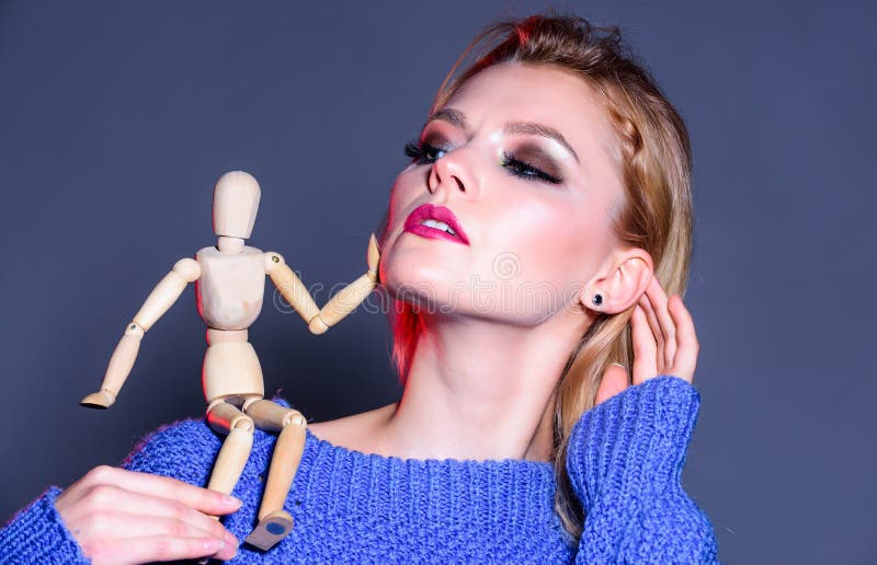 Sexy woman with fashion makeup. wooden figure on shoulder of girl. natural beauty. artificial fashion. vogue concept royalty free stock photo Sexy woman with fashion makeup. wooden figure on shoulder of girl. natural beauty. artificial fashion. vogue concept royalty free stock photo