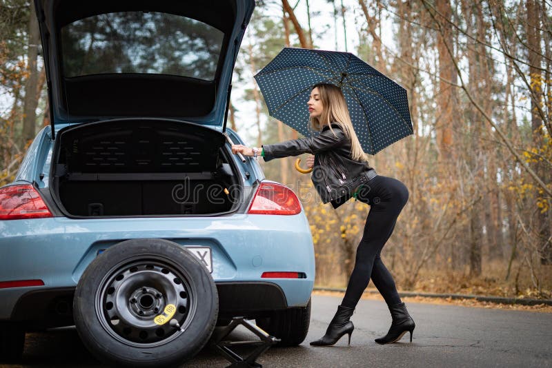 Woman on the Heels with Broken Car on the Empty Road Waits for Help