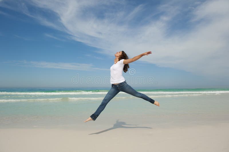 woman jumping happy at beach