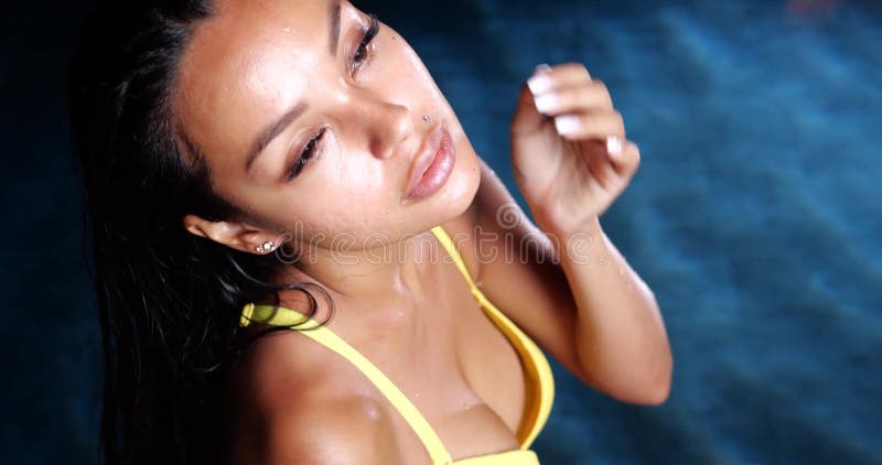 Sexy woman in the swimming pool at night