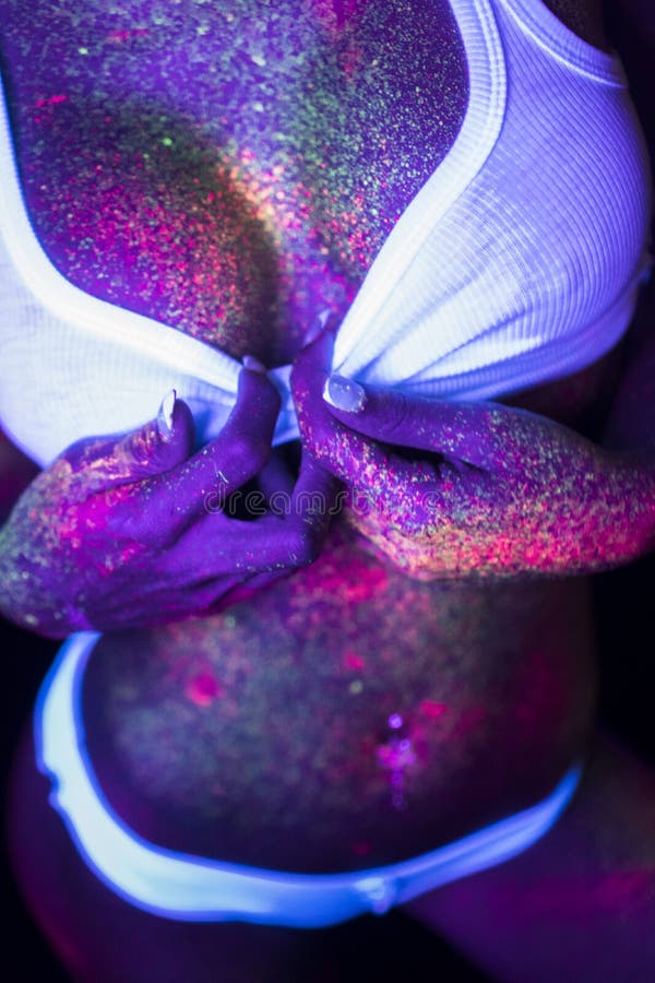 woman with UV fluorescent face and body makeup stock photo woman with UV fluorescent face and body makeup stock photo